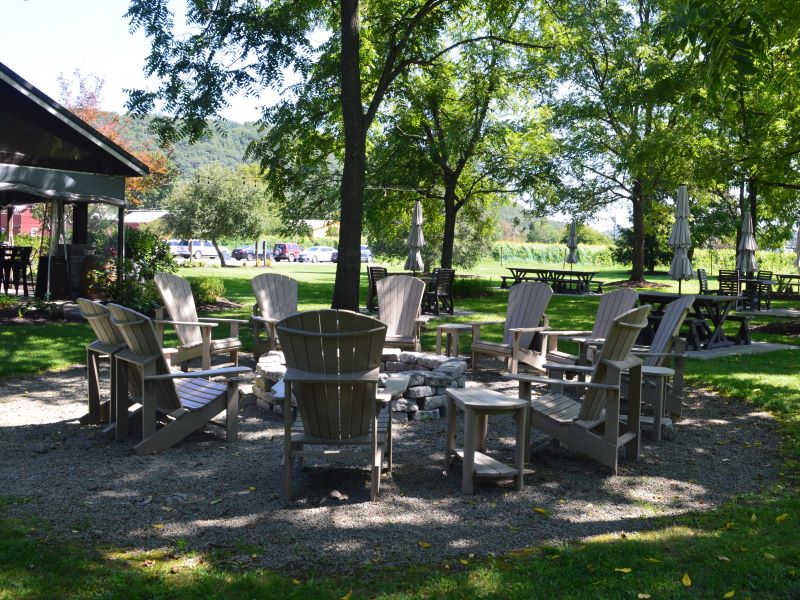 Adirondack chairs around a fire pit