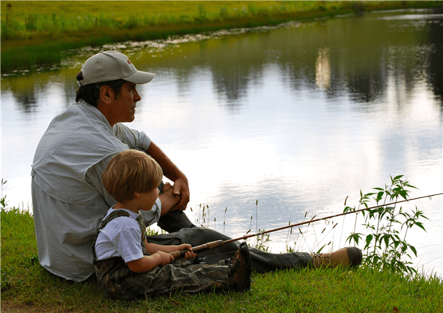 Grand Prize Winner: Fishing Buddies. Photographer-Heather Hohenwarter. Picture of a young boy fishing with an older man.