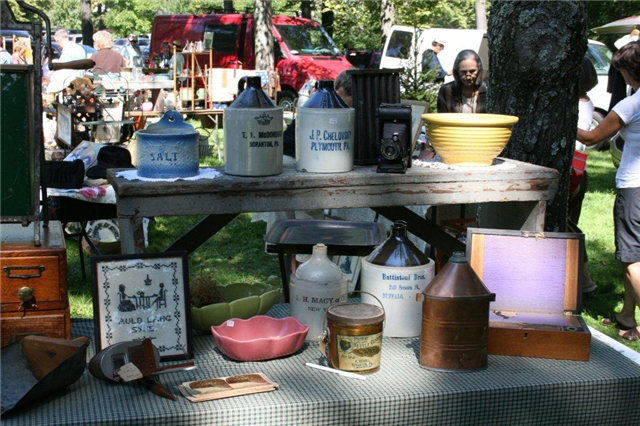 Antique jugs and other items on display.