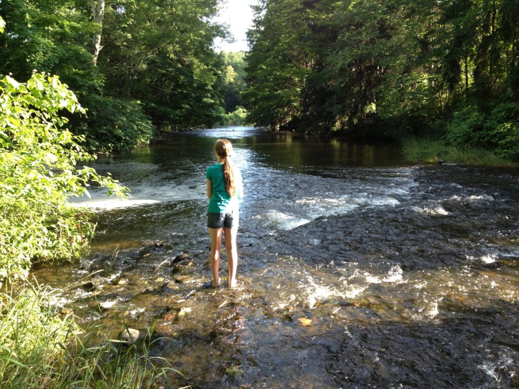 A girl fishes in Tunkhannock Creek