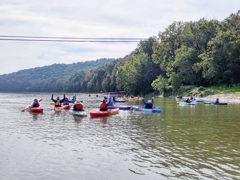 A group of kayakers paddle on the Susquehanna River