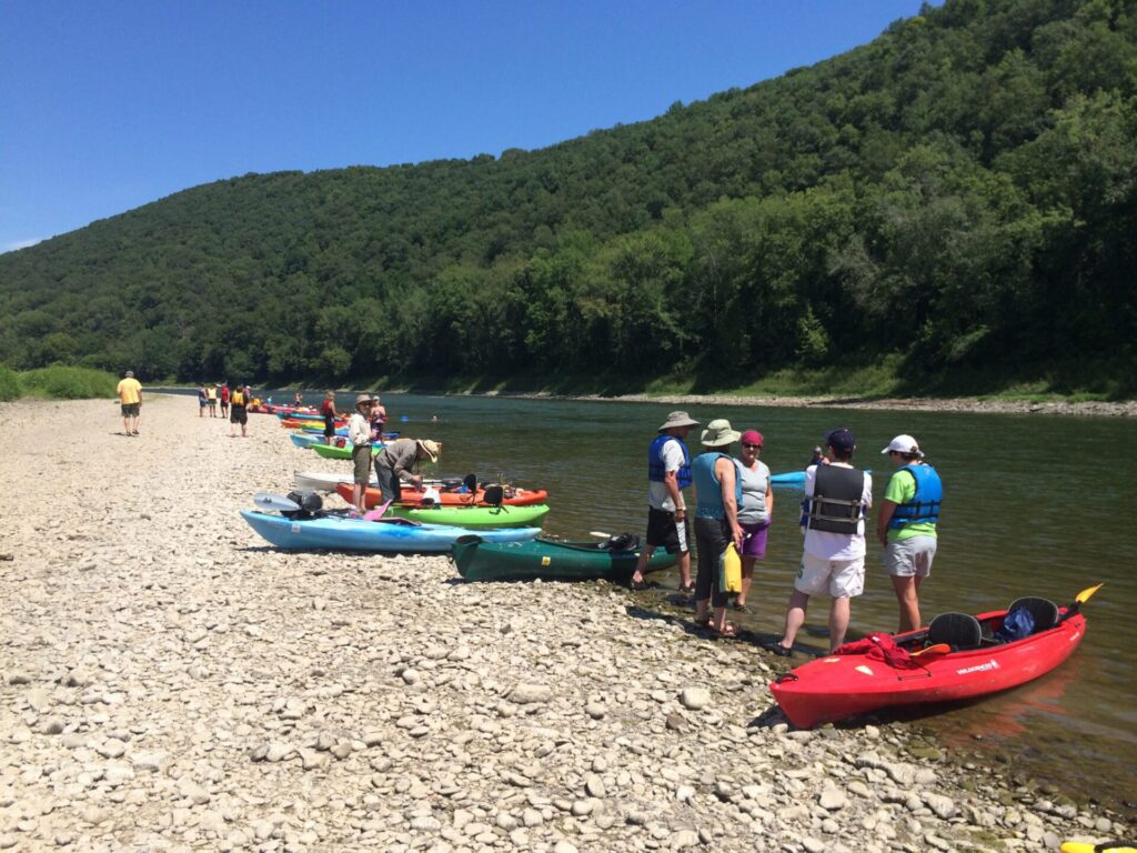 Kayaks along the shore of the river