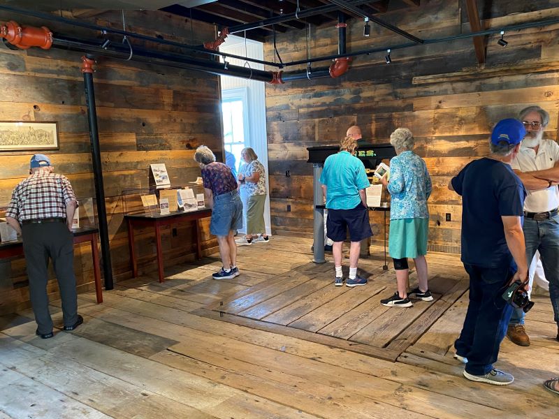 Visitors look at displays about Nicholson's history