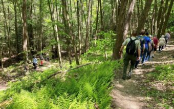A group of hikers walk down a switchback on on of Countryside Conservancy's preserves