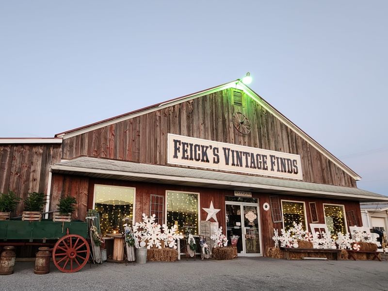 Exterior of Feick's Vintage Finds at Muncy, a barnwood building with country decor outside