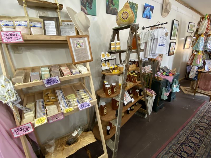 Store racks displaying homemade soaps and honey