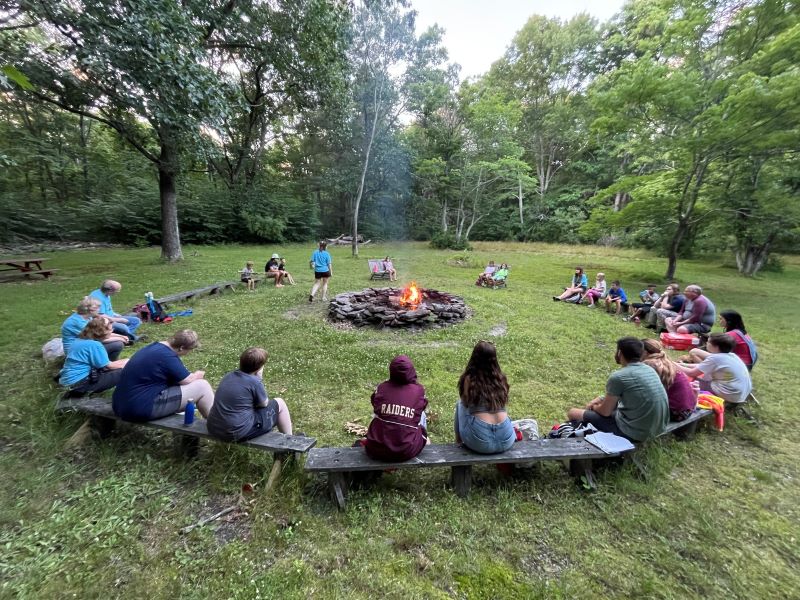 Kids gather around a campfire at Camp Lackawanna