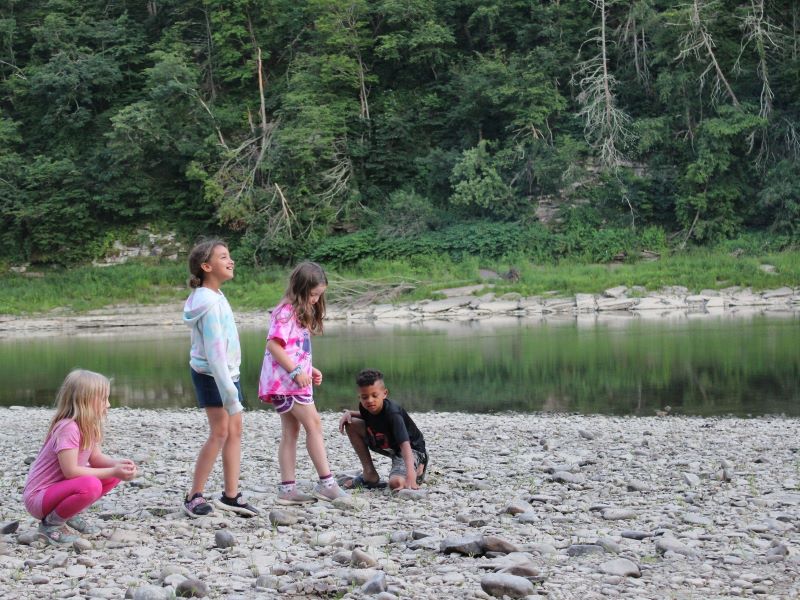 Four children play on the shores of the Susquehanna River