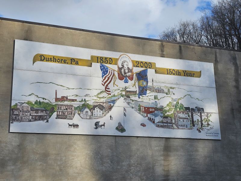 A mural depicting a historic streetscape of Dushore, PA
